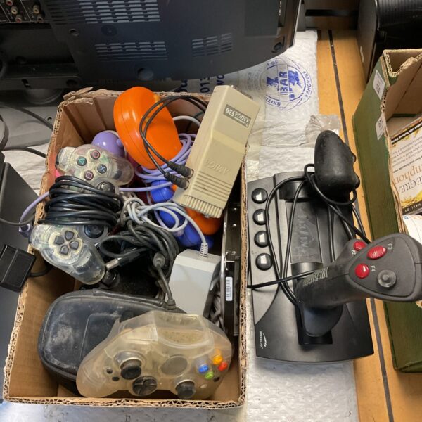 Mixed lot of Xbox and PlayStation gaming controllers for retro gaming.