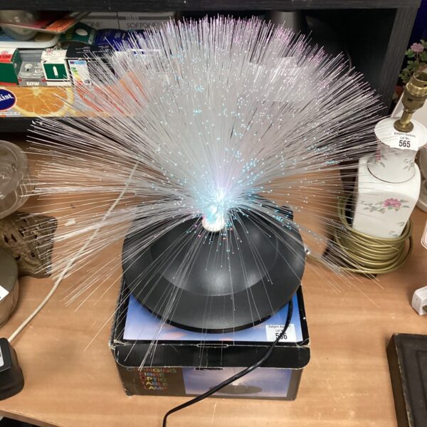 Colour changing fibre optic lamp with radiating strands.