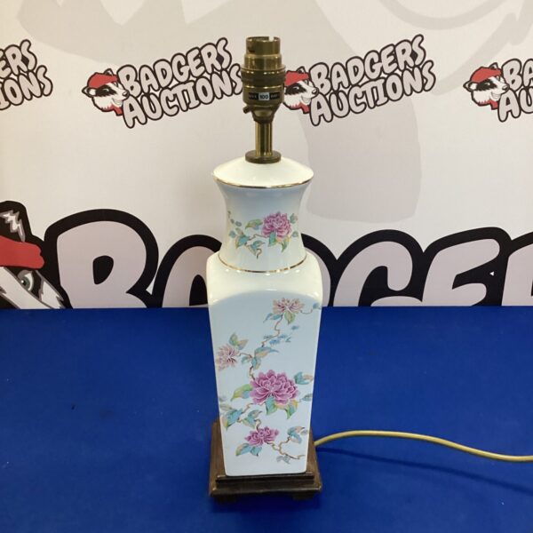 Vintage porcelain table lamp with delicate floral pattern.