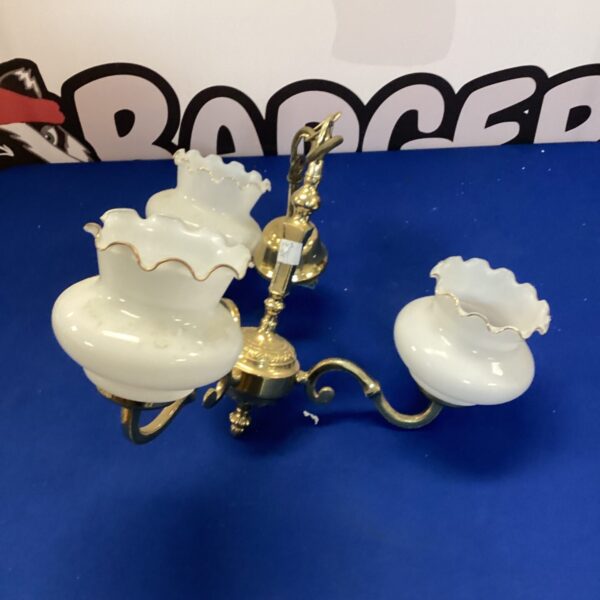Ornate brass ceiling chandelier with glass shades.