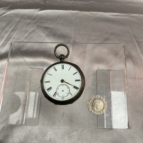Antique silver pocket watch with Roman numerals, front view.