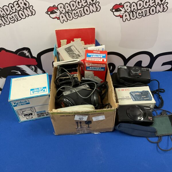 Vintage camera lot with Olympus and Canon cameras and accessories.