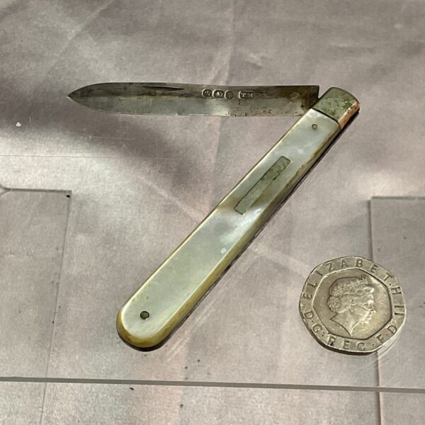 Antique silver fruit knife with iridescent mother of pearl handle.