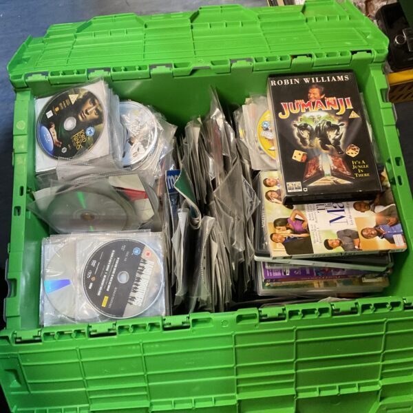 Large crate filled with assorted DVDs and Blu-ray discs.