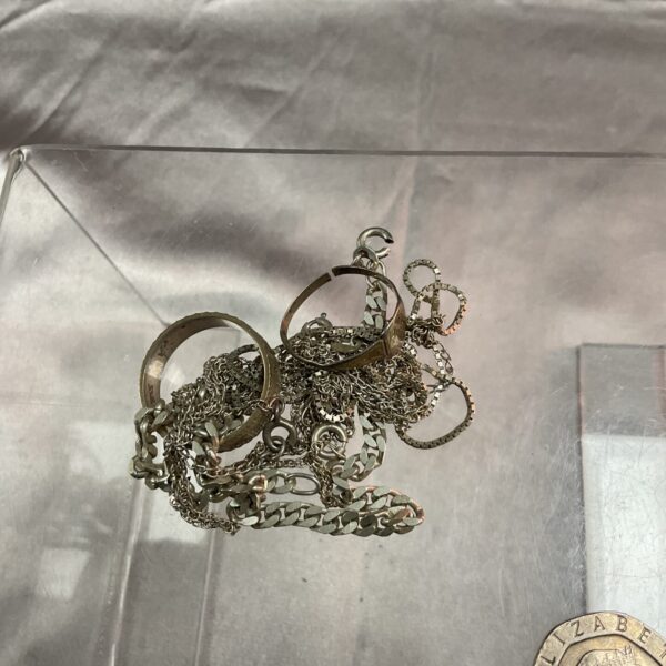 Mixed scrap silver jewellery lot with chains and pendants.