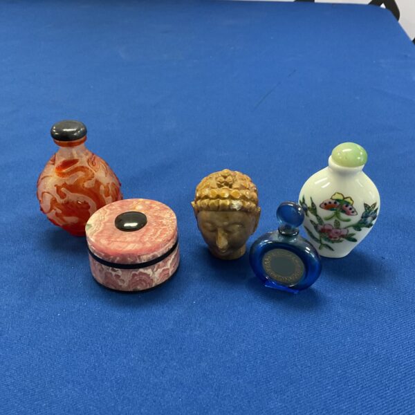 Vintage oriental scent bottles and stone Buddha head collection.