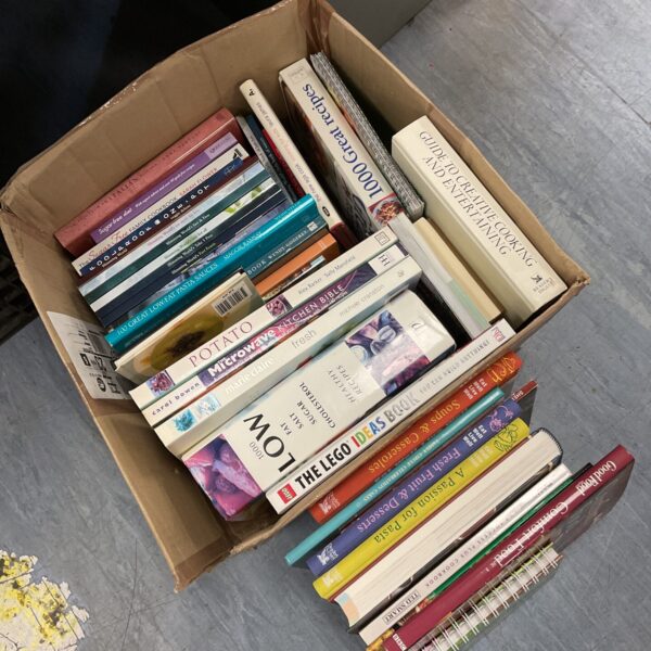 Stack of vintage and modern cooking books for culinary inspiration.