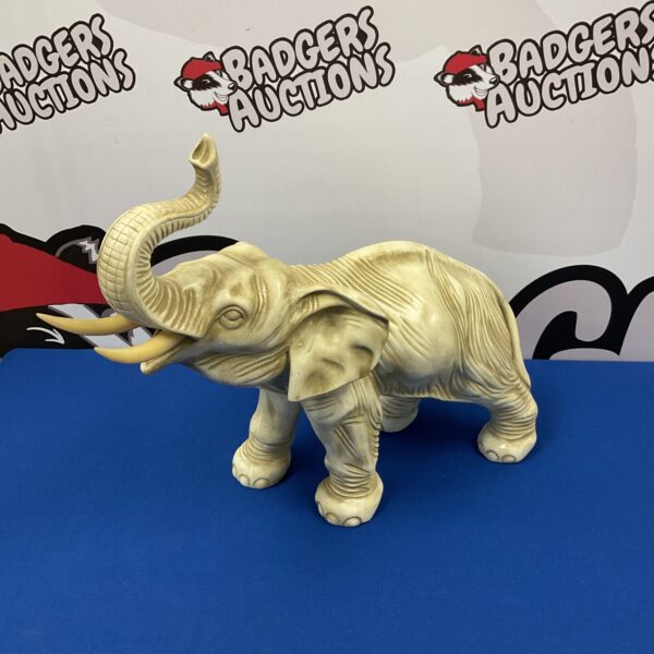 Detailed large ceramic elephant statue for home decor.