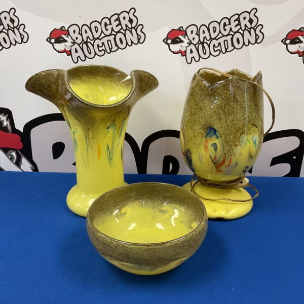 Vibrant Scottish art glass vase with yellow and orange swirls.