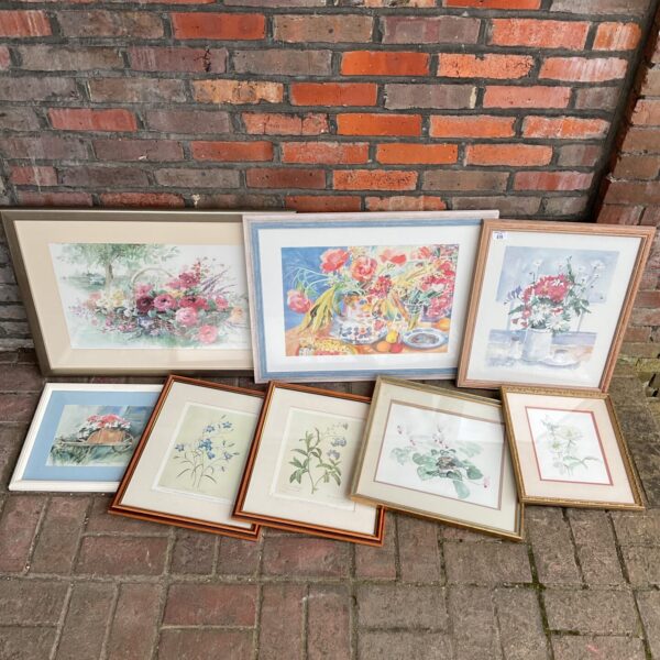 Collection of framed still life prints and watercolour paintings with floral arrangements.