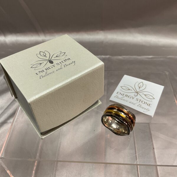 Close-up of sterling silver spinner ring with energy stone detail.