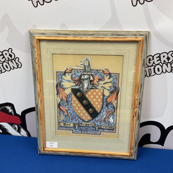 Detailed watercolour painting of a heraldic crest in a frame.