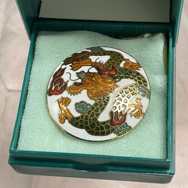Vintage Chinese enamel dragon brooch with intricate detailing.
