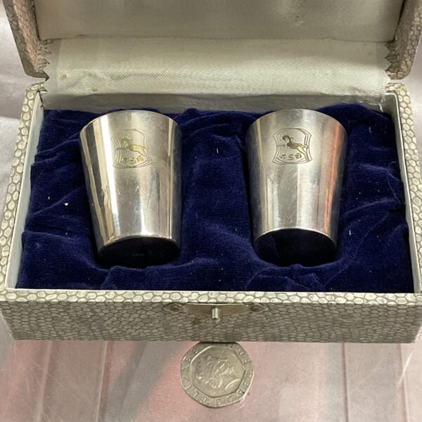 Antique Chinese silver gilt cups presented in a patterned case.