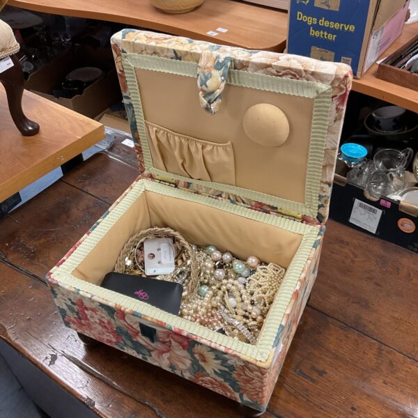 Vintage floral sewing box filled with costume jewellery.