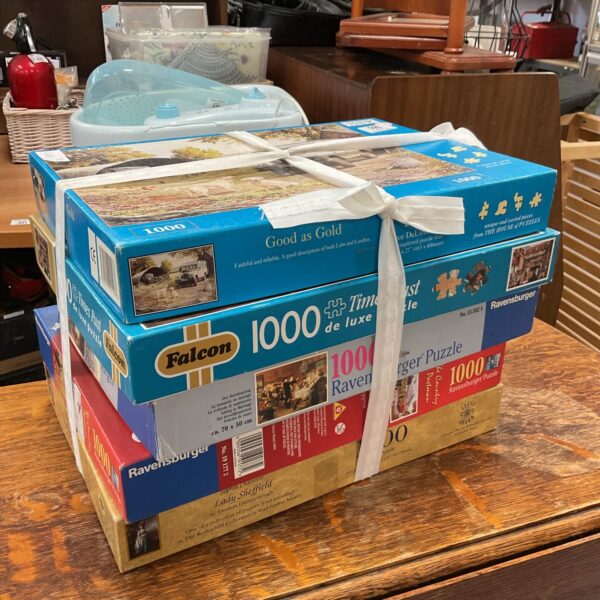 Bundle of five 1000-piece jigsaw puzzles from Falcon and Ravensburger.