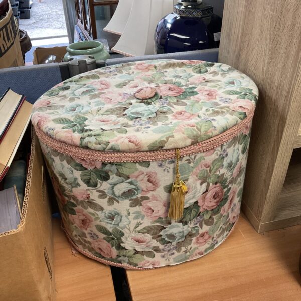 Vintage floral storage box with a patterned fabric cover.