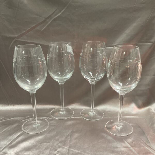 Set of four Waterford John Rocha crystal wine glasses on display.