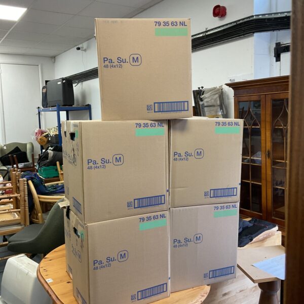 Five sealed boxes of Tena Pants medium size incontinence supplies.