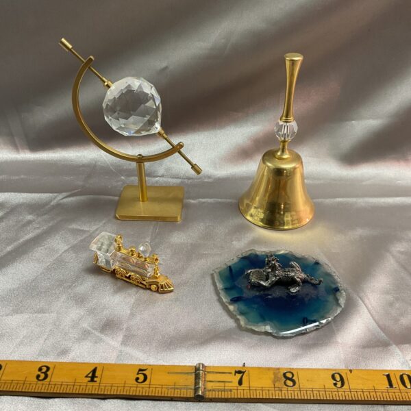 Detailed Swarovski crystal globe ornament on a stand.