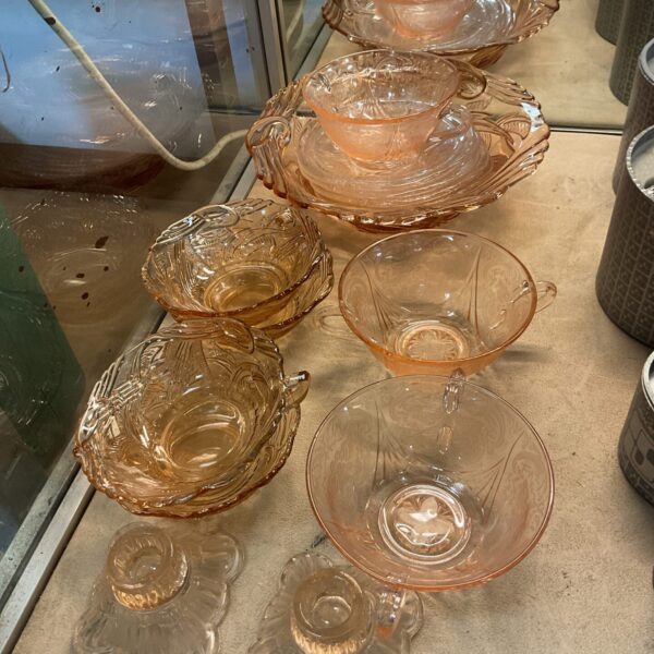 Pink depression glass collection with floral details.