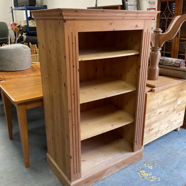 Rustic pine bookcase with two shelves, ideal for farmhouse decor.