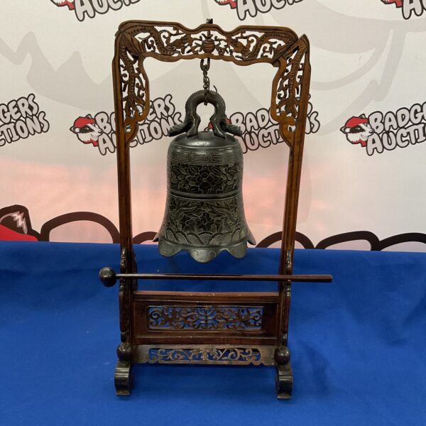 Antique Chinese temple bell with floral bronze and carved frame.