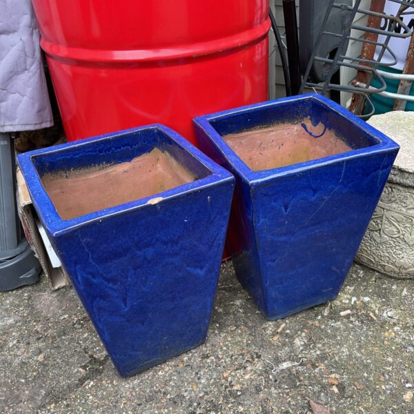 Pair of vibrant blue glazed garden pots for outdoor plants.