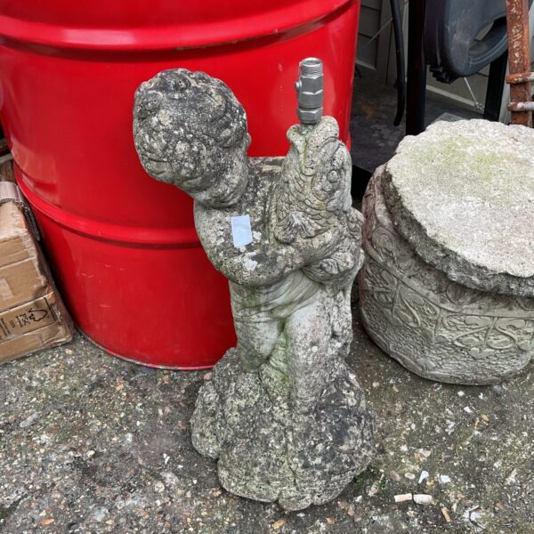 Vintage concrete boy and fish garden fountain sculpture.
