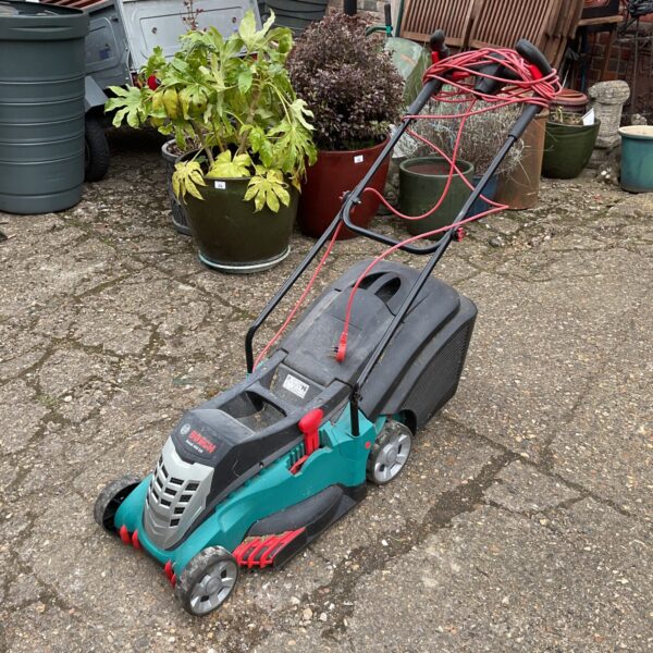 Used Bosch Rotak 400 electric lawn mower in a garden setting.