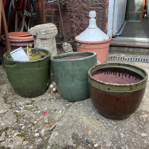 Lot of three vintage green glazed terracotta plant pots for garden use.