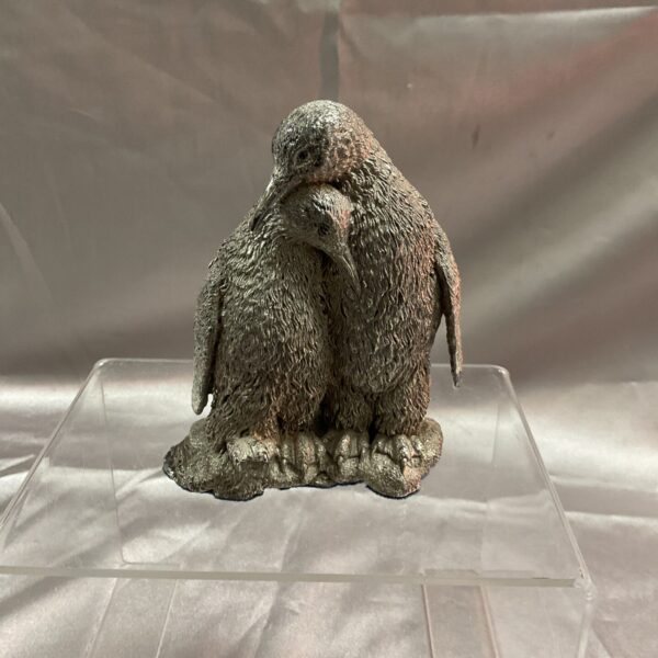 Silver resin penguin pair, hallmarked collectible figurines.