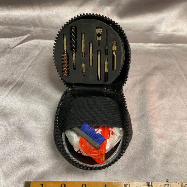 Open Otis pistol cleaning kit showing tools inside.