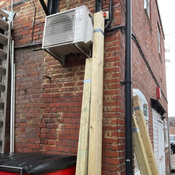 Fujitsu air conditioning unit with timber bundles for DIY projects.
