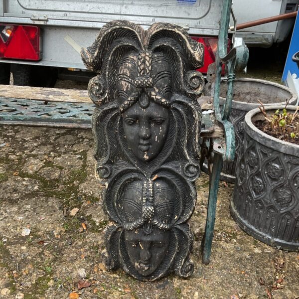 Dark carved wooden tribal wall mask with intricate facial details.