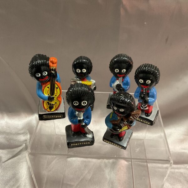 Vintage Robertson golly band figures playing instruments, collectible toys.