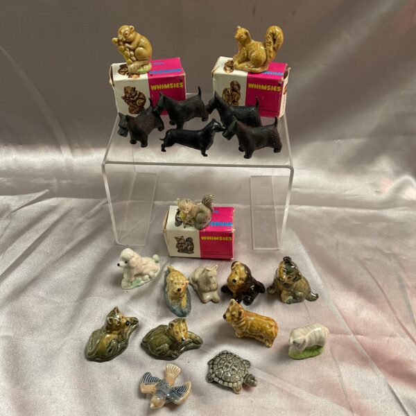 Vintage Wade dog figures and pottery collection on display.