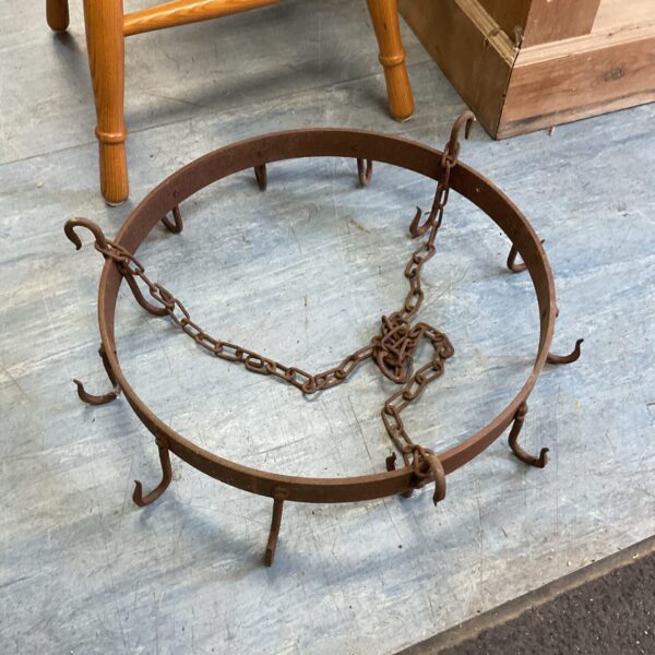 Vintage wrought iron ceiling hooks with chain links.