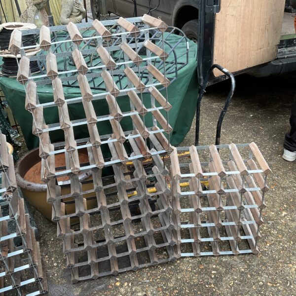 Vintage metal wine rack with square grid pattern.