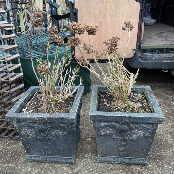 Pair of large decorative garden plant pots with embossed detailing.