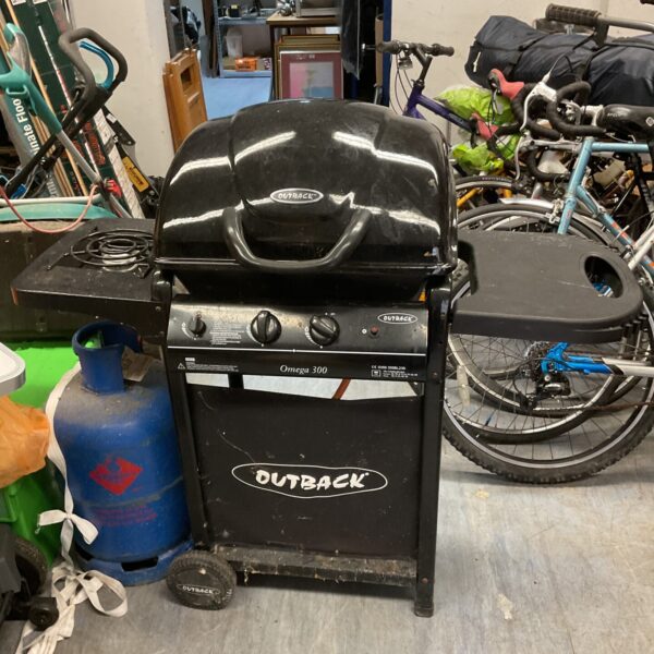 Portable Outback gas BBQ with gas bottle for outdoor cooking.