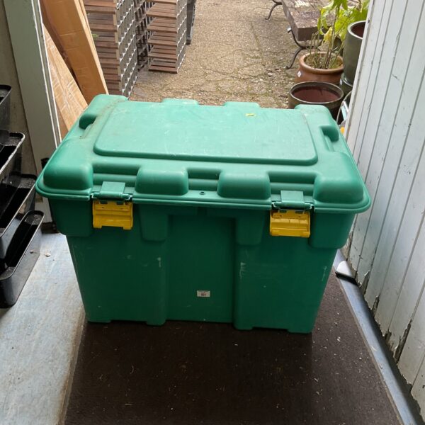 Large green plastic storage box for garden or utility use.