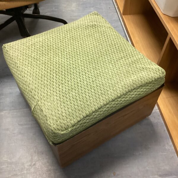 Vintage green storage ottoman with lift-top, mid-century modern style.