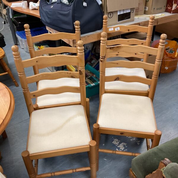 Set of four vintage ladder back pine dining chairs.
