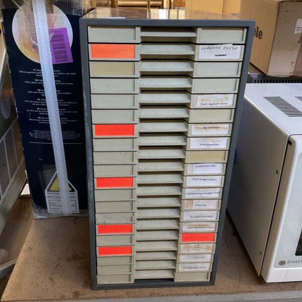 Vintage metal stationary cabinet with twenty drawers for office storage.
