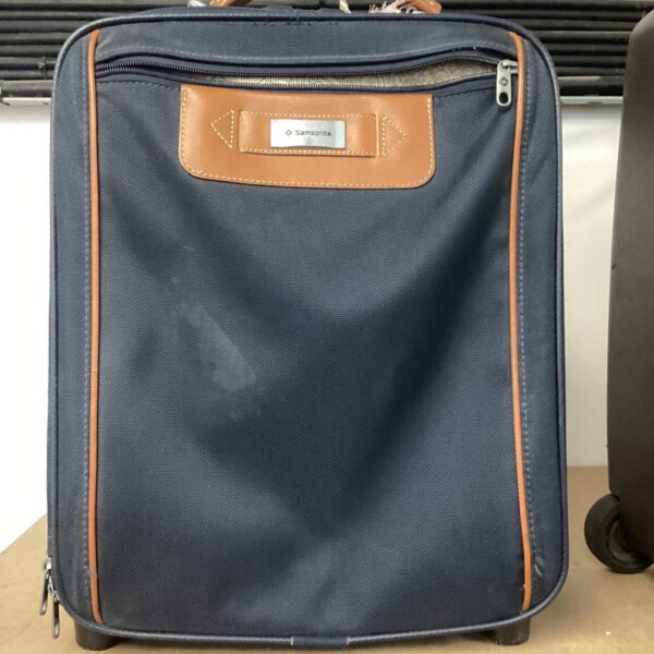 Vintage Samsonite wheeled suitcase with pull handle.