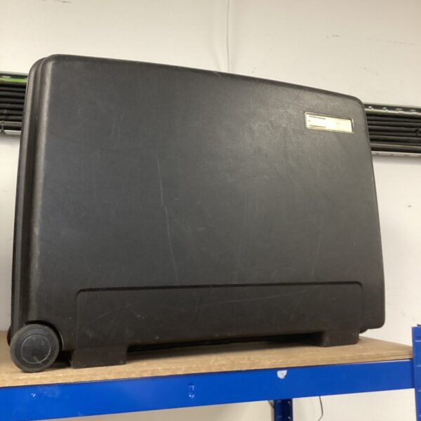 Vintage Delsey wheeled suitcase with black hard shell.