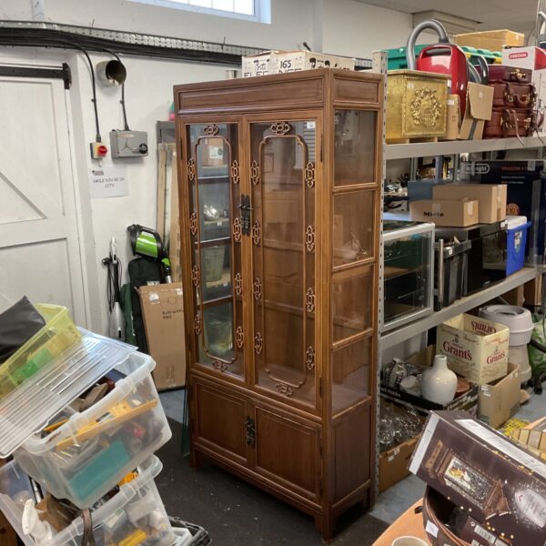 Vintage oriental display cabinet with glass front for collectibles.