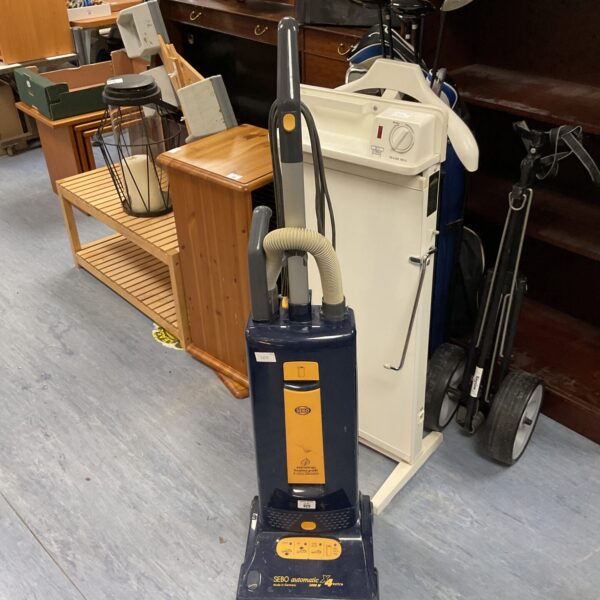 Vintage Debo Automatic X4 vacuum cleaner in a home setting.
