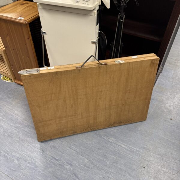 Vintage folding decorators table with wooden top and metal frame.